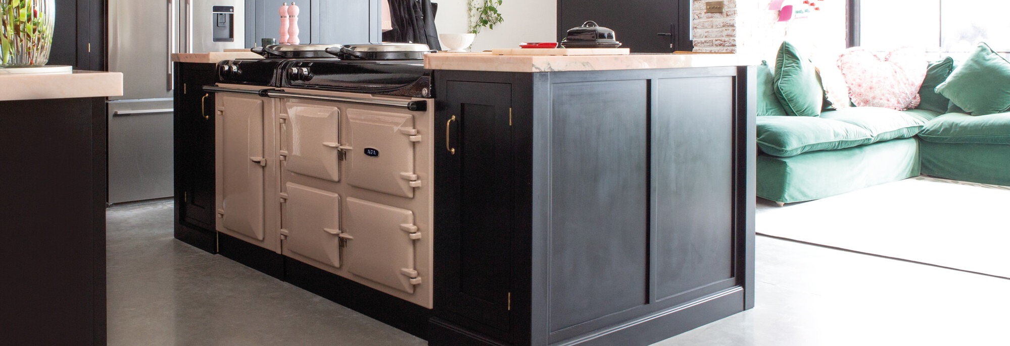 AGA eR3 160 5i in Blush finish in black kitchen island with rose coloured marble top.