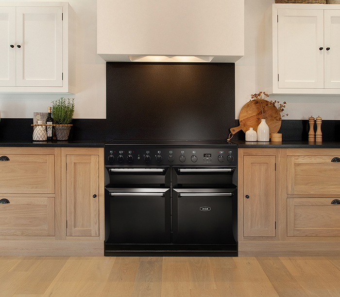 Front view of Masterchef Deluxe 110 in Black in wood finish kitchen.