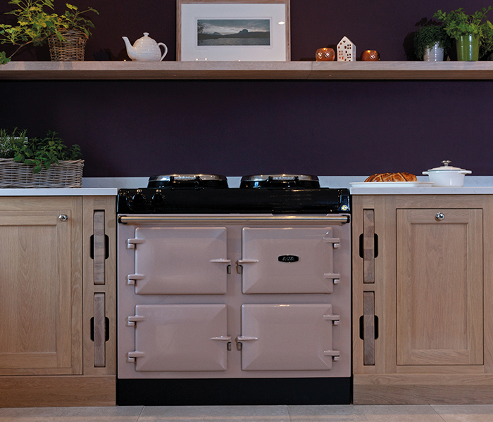 A blush coloured R3 AGA in a low-lit kitchen.